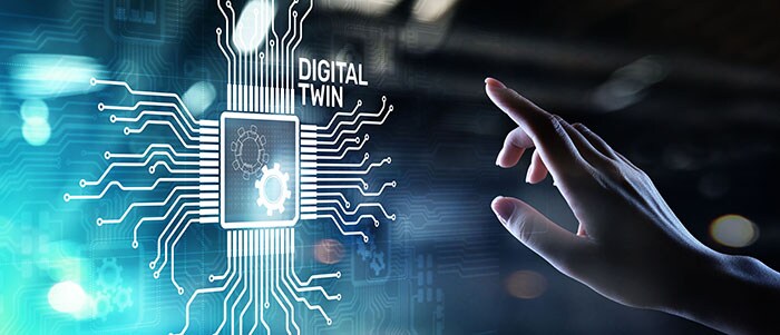 finger touching hologram of circuit with the words Digital Twin next to it