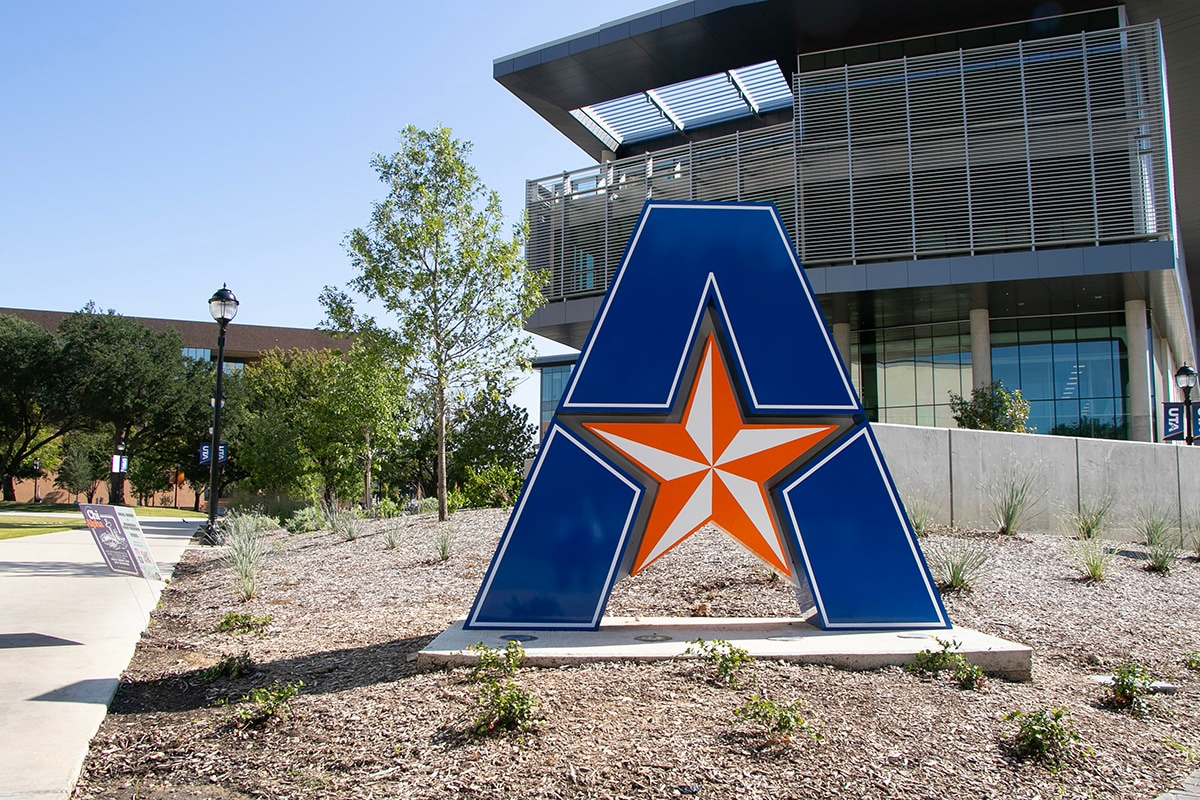 UTA logo sign on the ground outside of a building - opens in a new tab