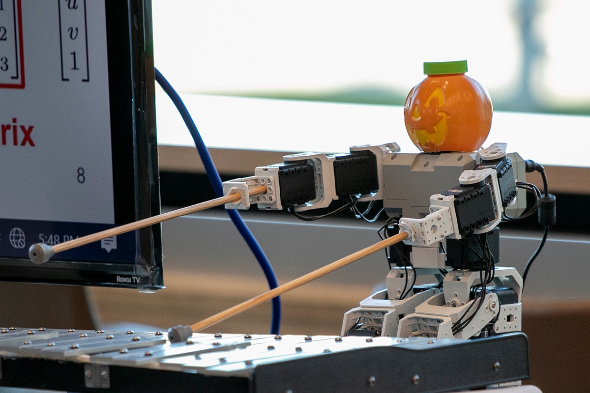 Robot playing xylophone with a Jack-O-Lantern as a head - opens in a new tab