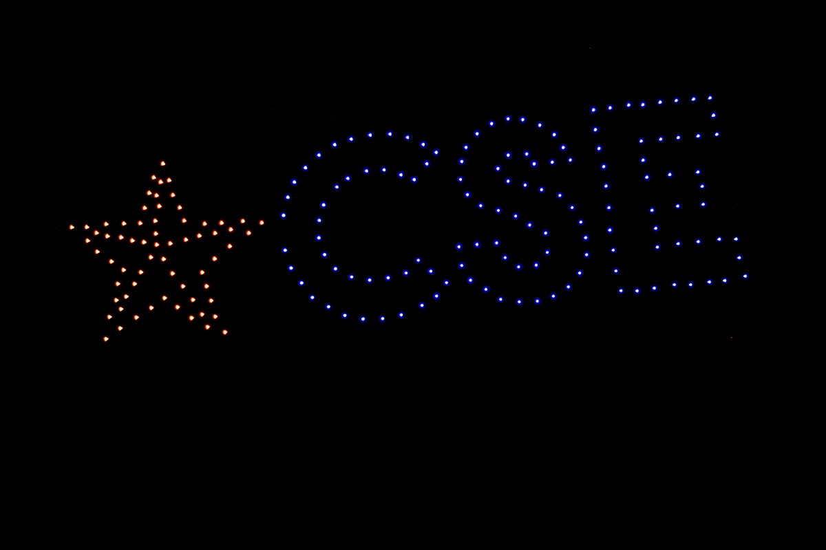 Drones against the night sky with lights spelling out CSE - opens in a new tab